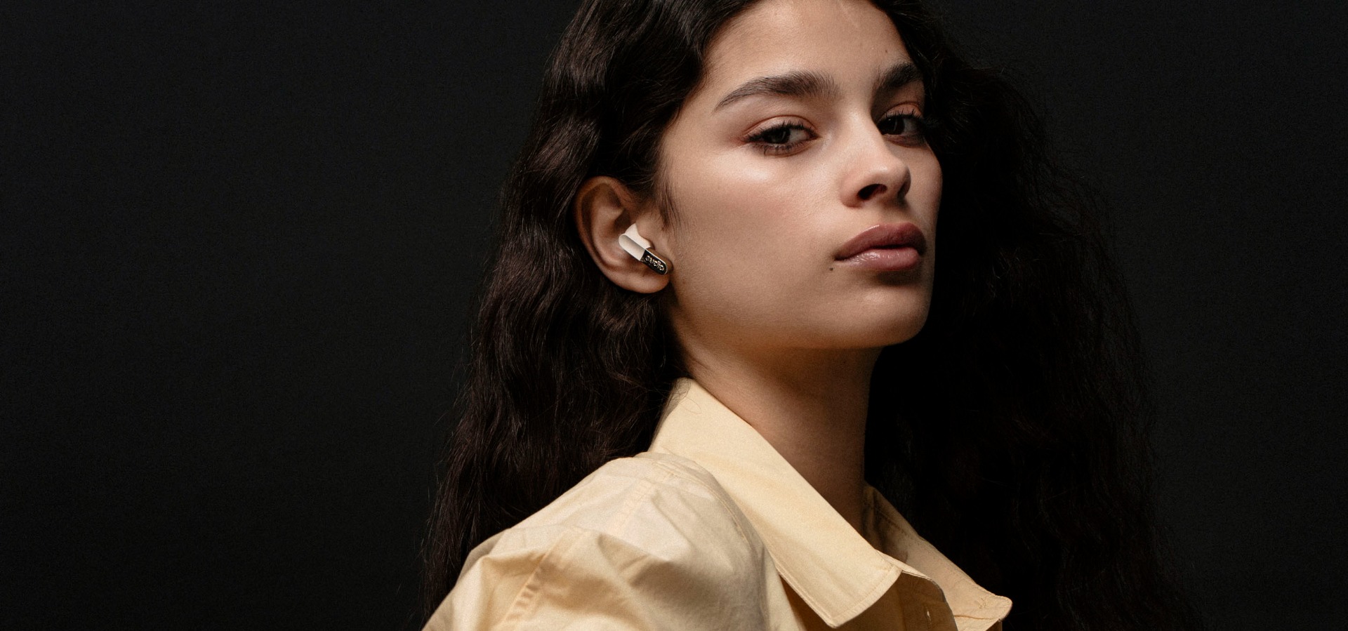 Sudio E3 Black TWS earbuds on a male model