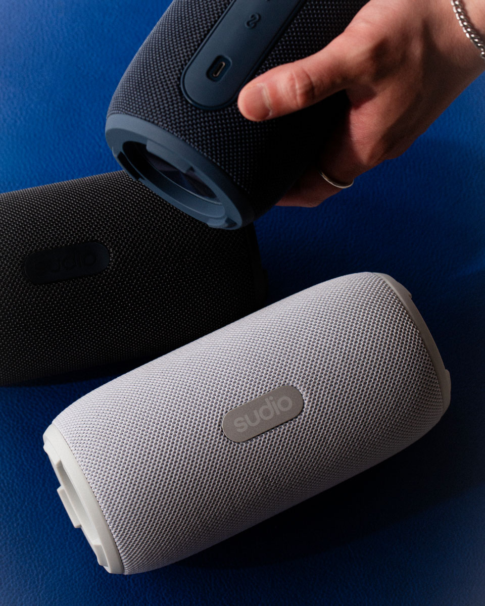a model holding Sudio F5 potable speaker